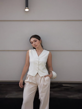 A girl wears a worsted wool vest